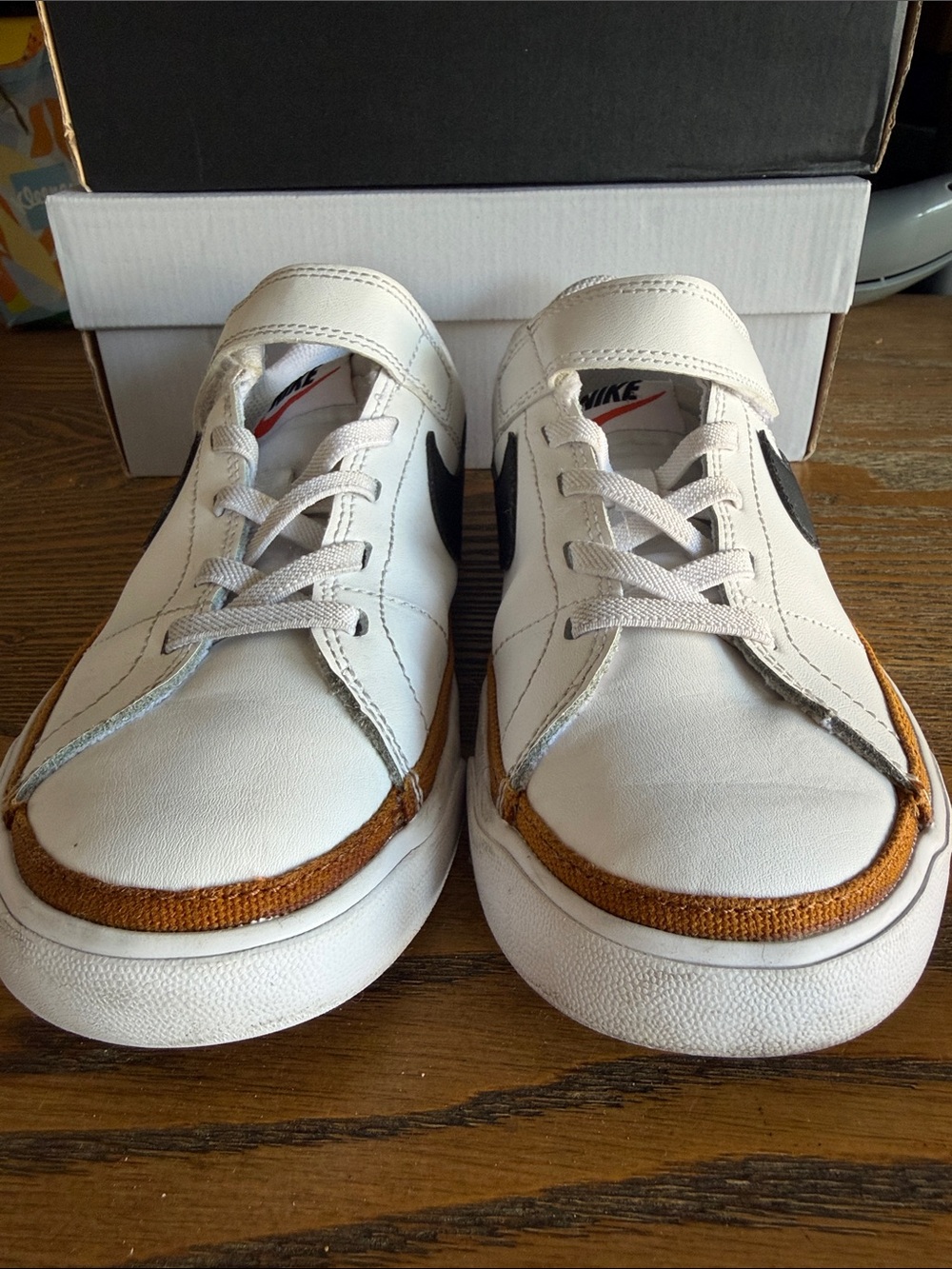 Nike Kids White Sneakers with Black Swoosh and Orange Accent